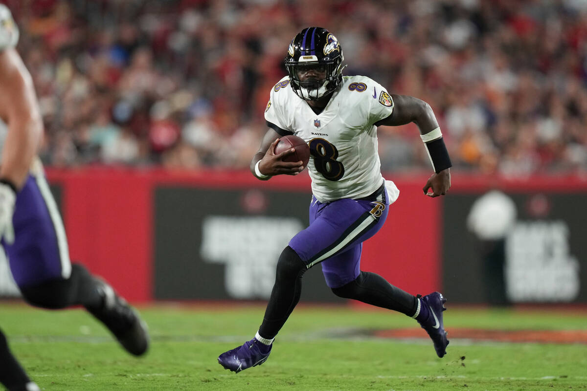Baltimore Ravens quarterback Lamar Jackson (8) runs on a keeper play during an NFL football gam ...