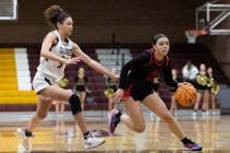 Coronado’s Kaylee Walters (14) dribbles around Faith Lutheran’s Leah Mitchell, le ...