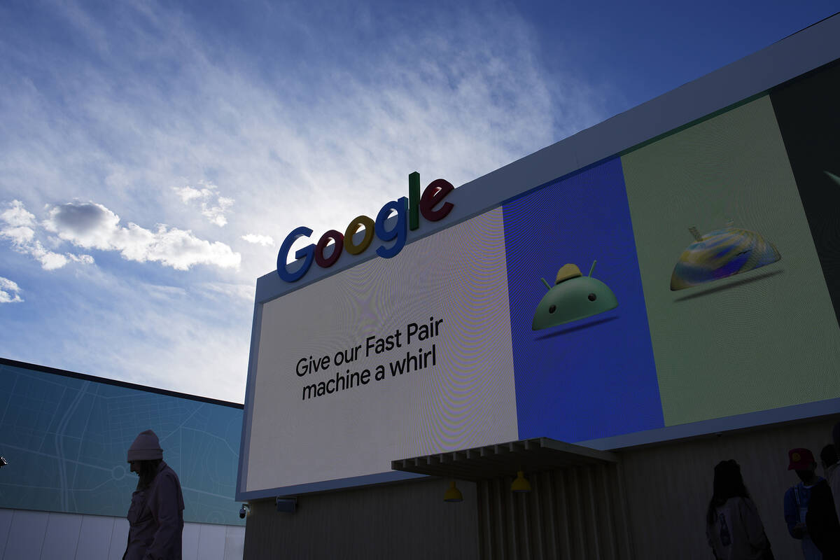 A person walks by the Google booth at the Las Vegas Convention Center before the start of the C ...