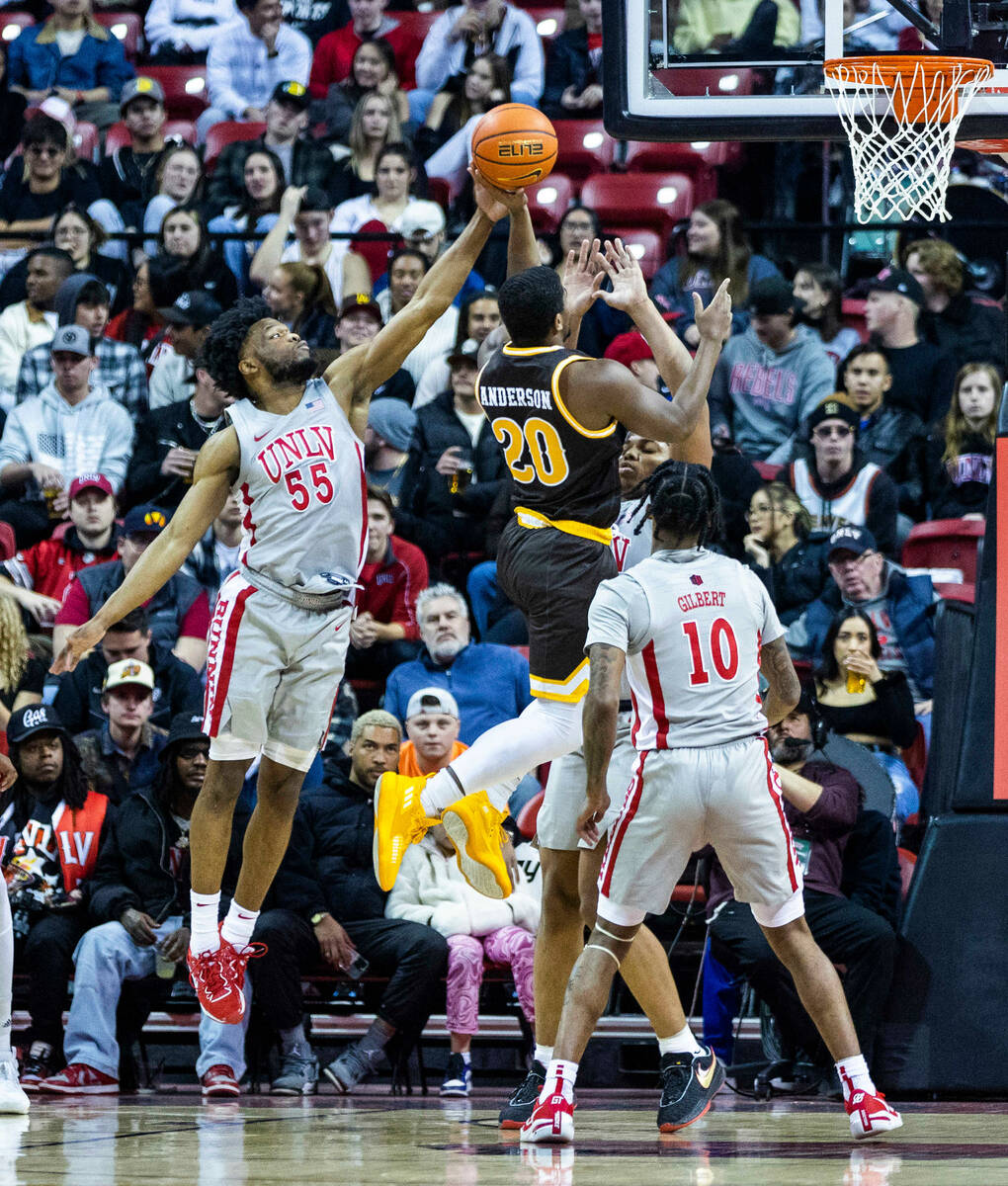 UNLV guard EJ Harkless (55) blocks a shot attempt by Wyoming guard Ethan Anderson (20) during t ...