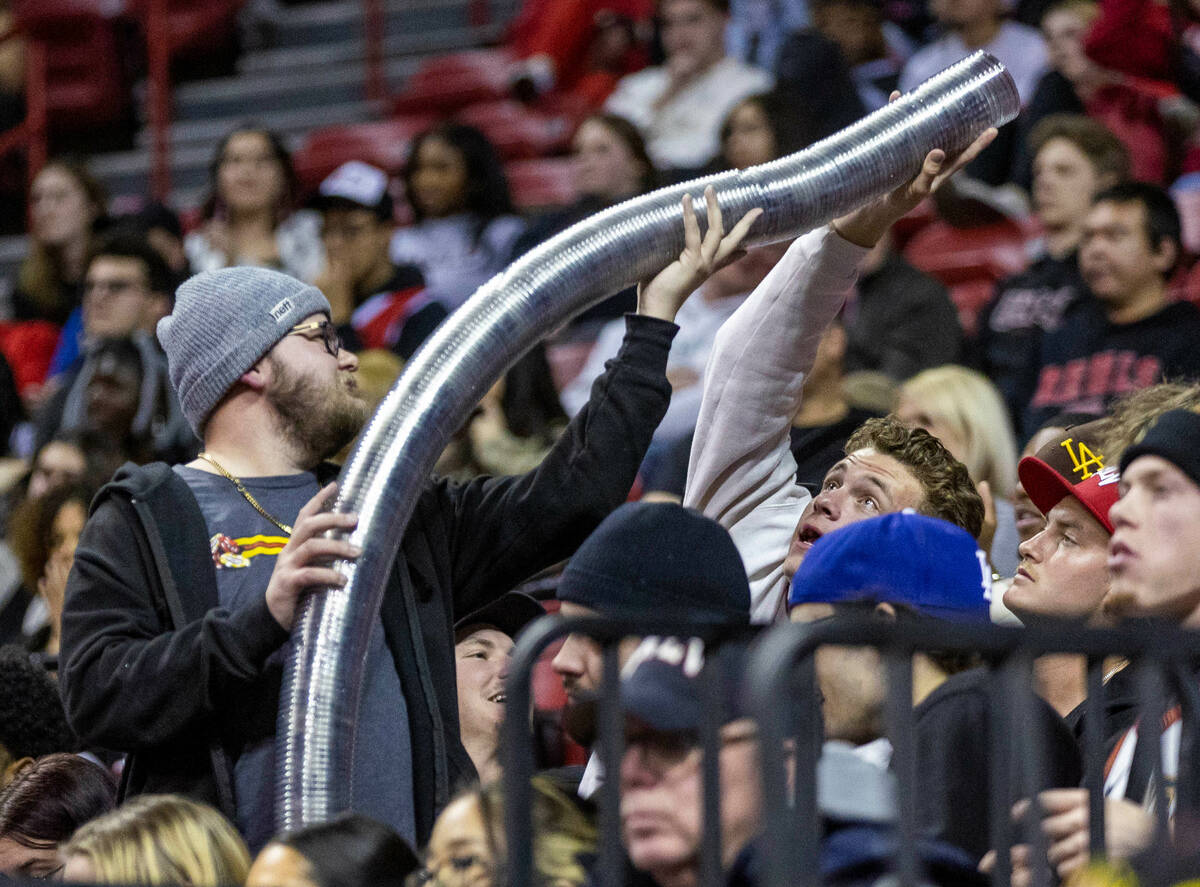 UNLV fans stack empty beer cups as they enjoy a game against Wyoming during the second half of ...