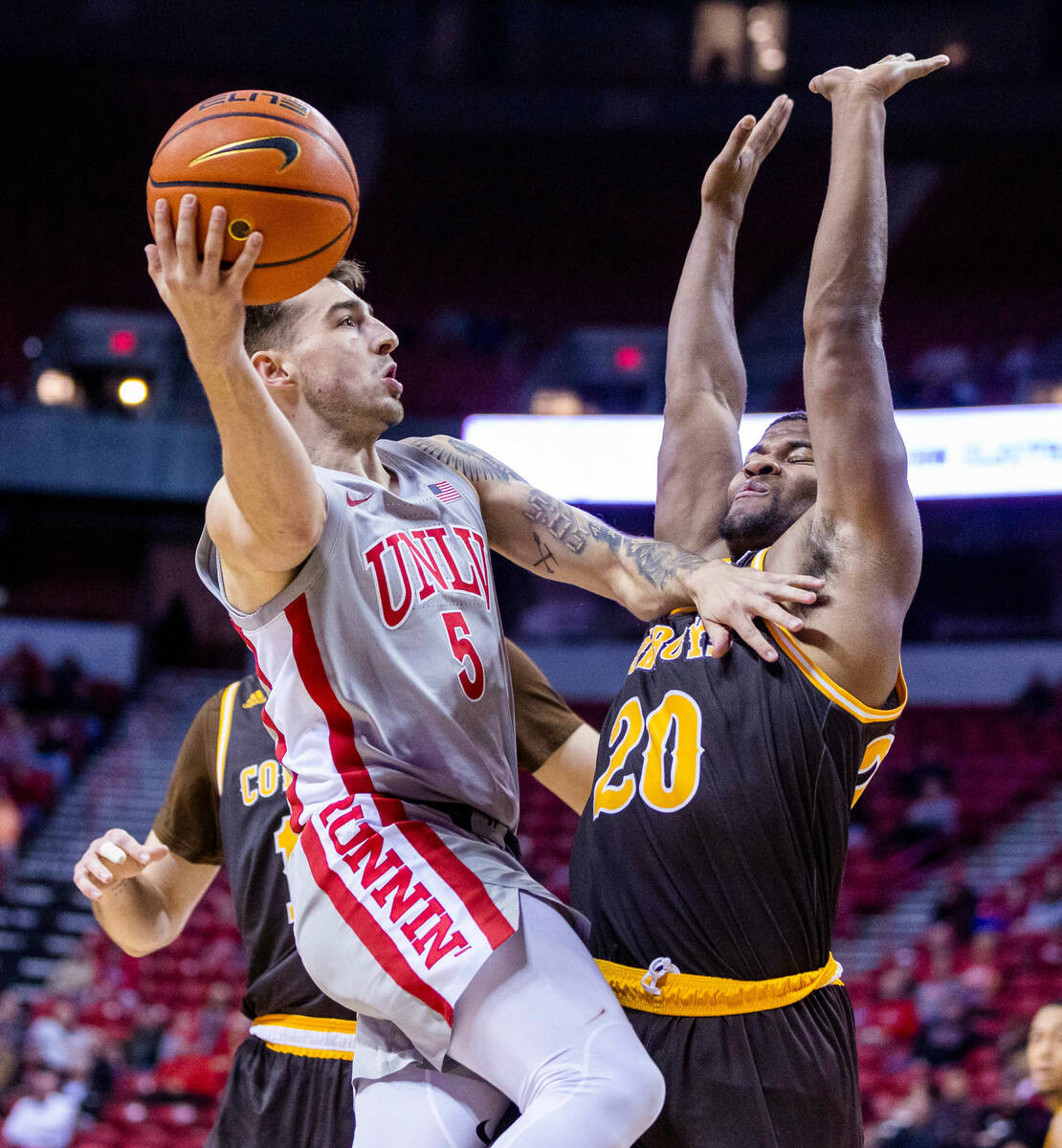 UNLV guard Jordan McCabe (5) elevates over Wyoming guard Ethan Anderson (20) for a score during ...