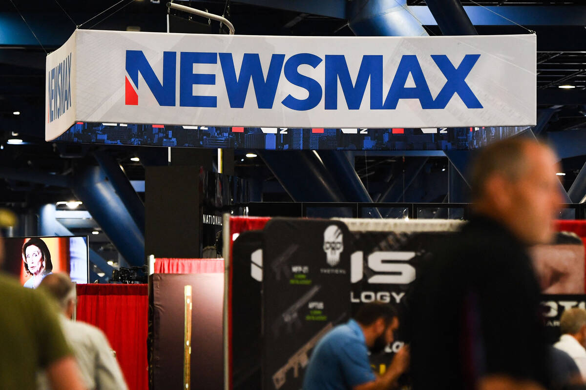Signage for the Newsmax conservative television broadcasting network is displayed at a broadcas ...