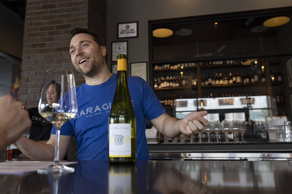 Eric Prato, sommelier and owner of Garagiste, chats with a guest at the downtown wine bar and b ...