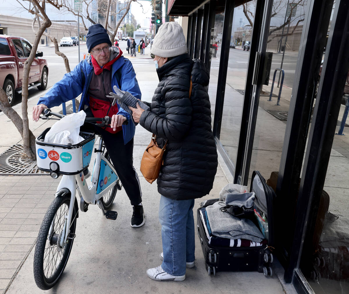 Richard Birmingham visits an unidentified woman during his daily bicycle outreach ride in downt ...