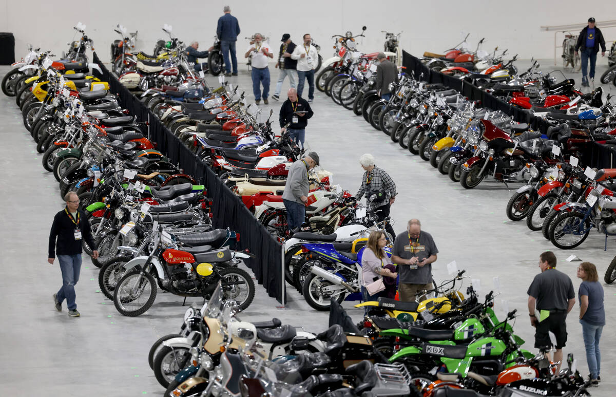People check out lots at the Mecum Las Vegas Vintage and Antique Motorcycle Auction at the Sout ...