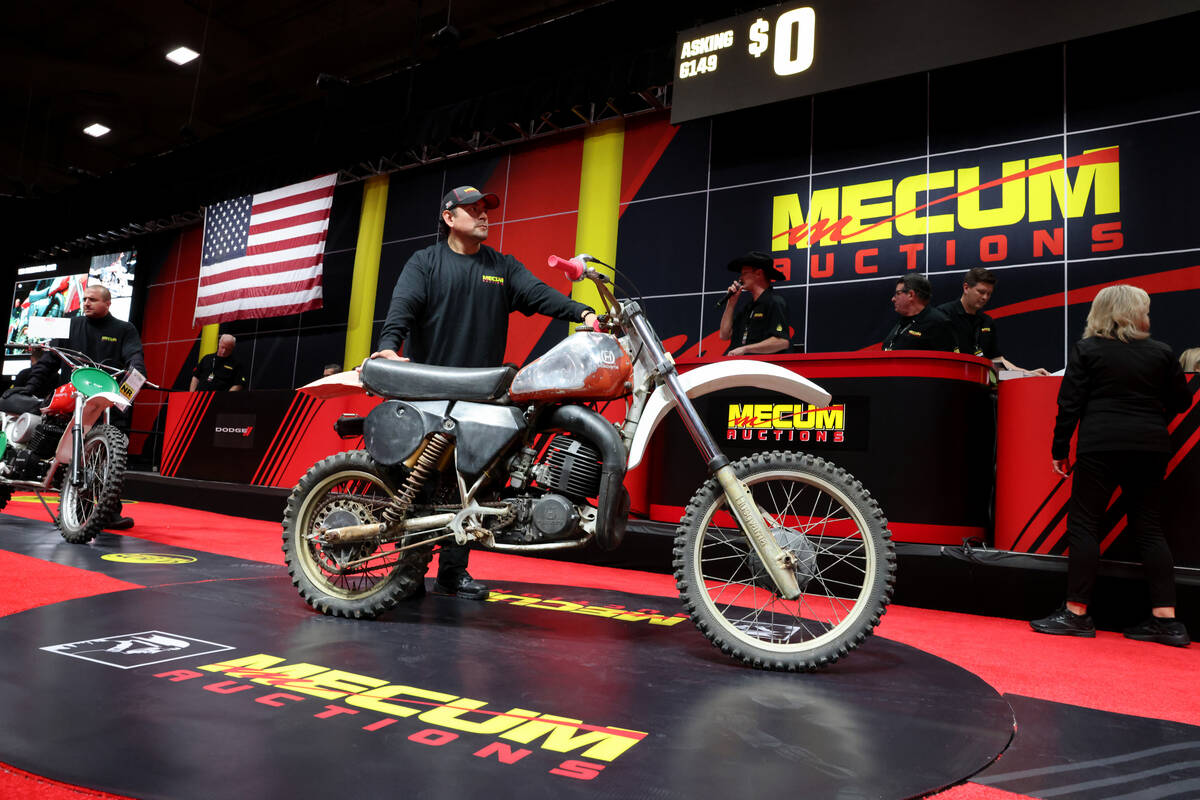 A pusher shows a 1981 Husqvarna 430CR on the auction block at the Mecum Las Vegas Vintage and A ...