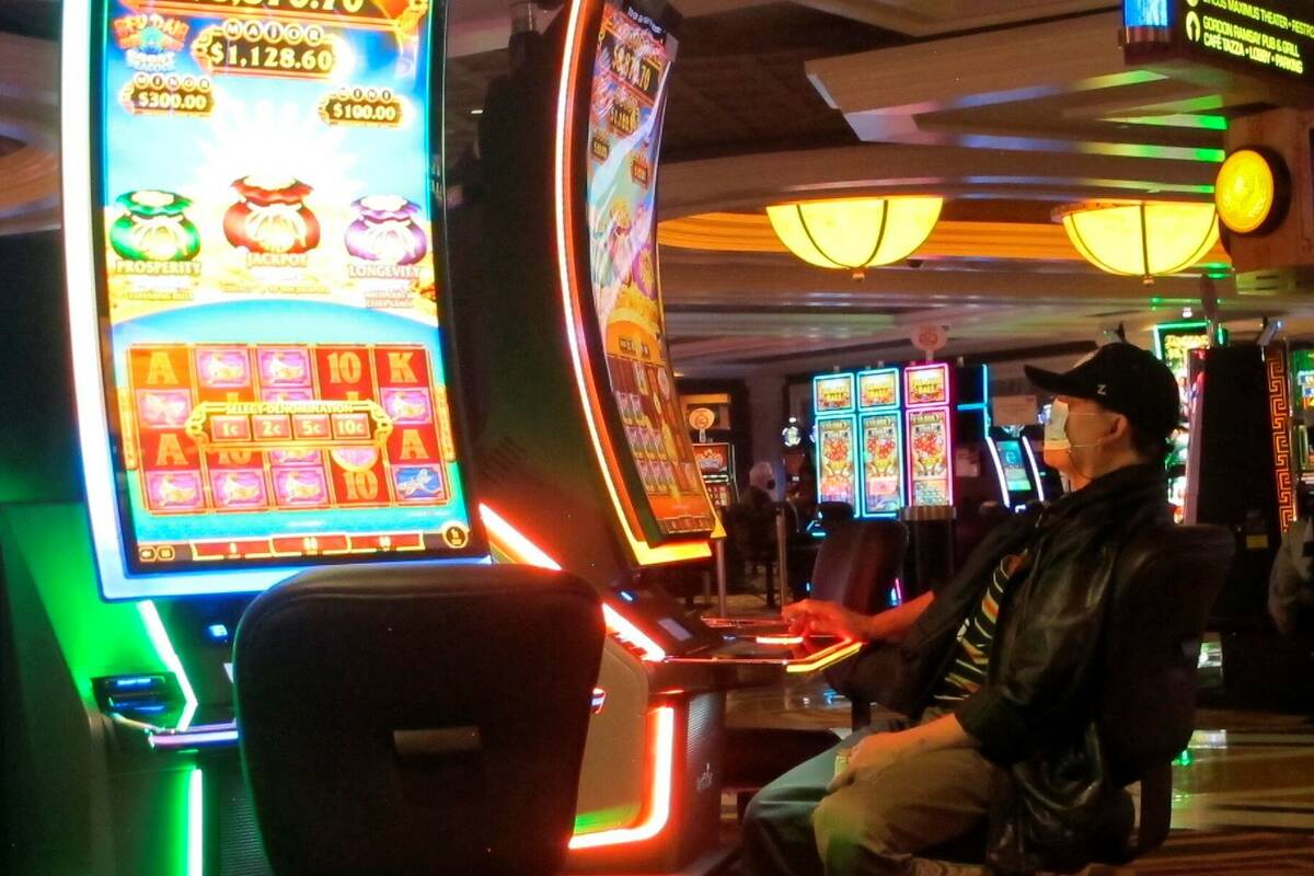 This Jan. 27, 2022, photo shows a gambler playing a slot machine at Caesars casino in Atlantic ...