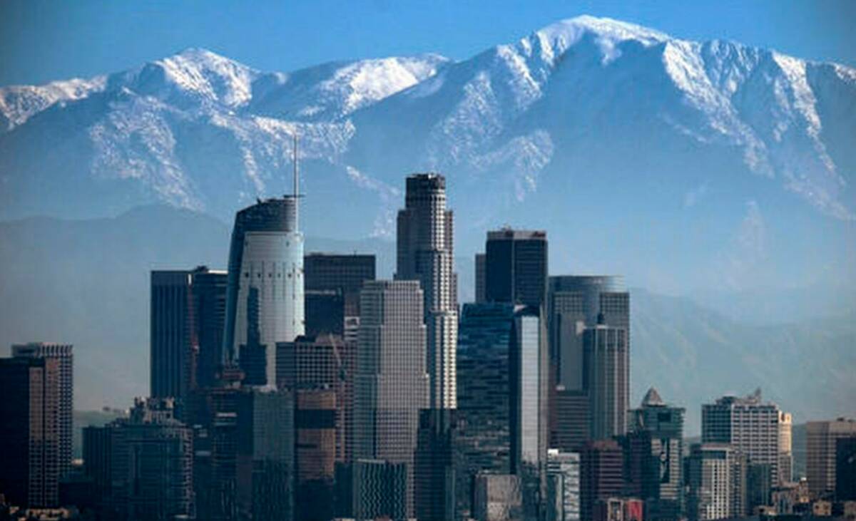 A snow-covered Mount Baldy, the highest peak among the San Gabriel Mountains, looms behind down ...