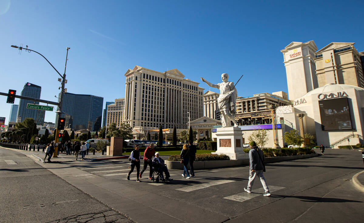 Pedestrians walk along the Las Vegas Strip outside of Caesars Palace on Thursday, Jan. 26, 2023 ...