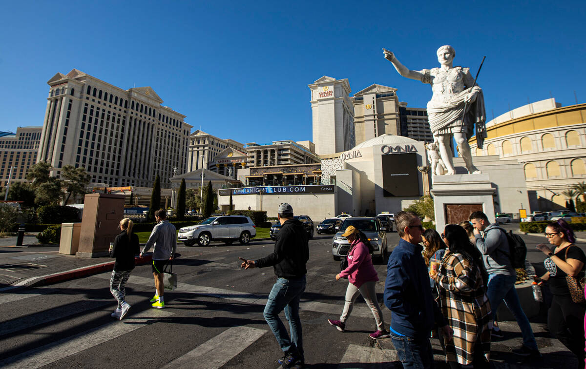 Pedestrians walk along the Las Vegas Strip outside of Caesars Palace on Thursday, Jan. 26, 2023 ...