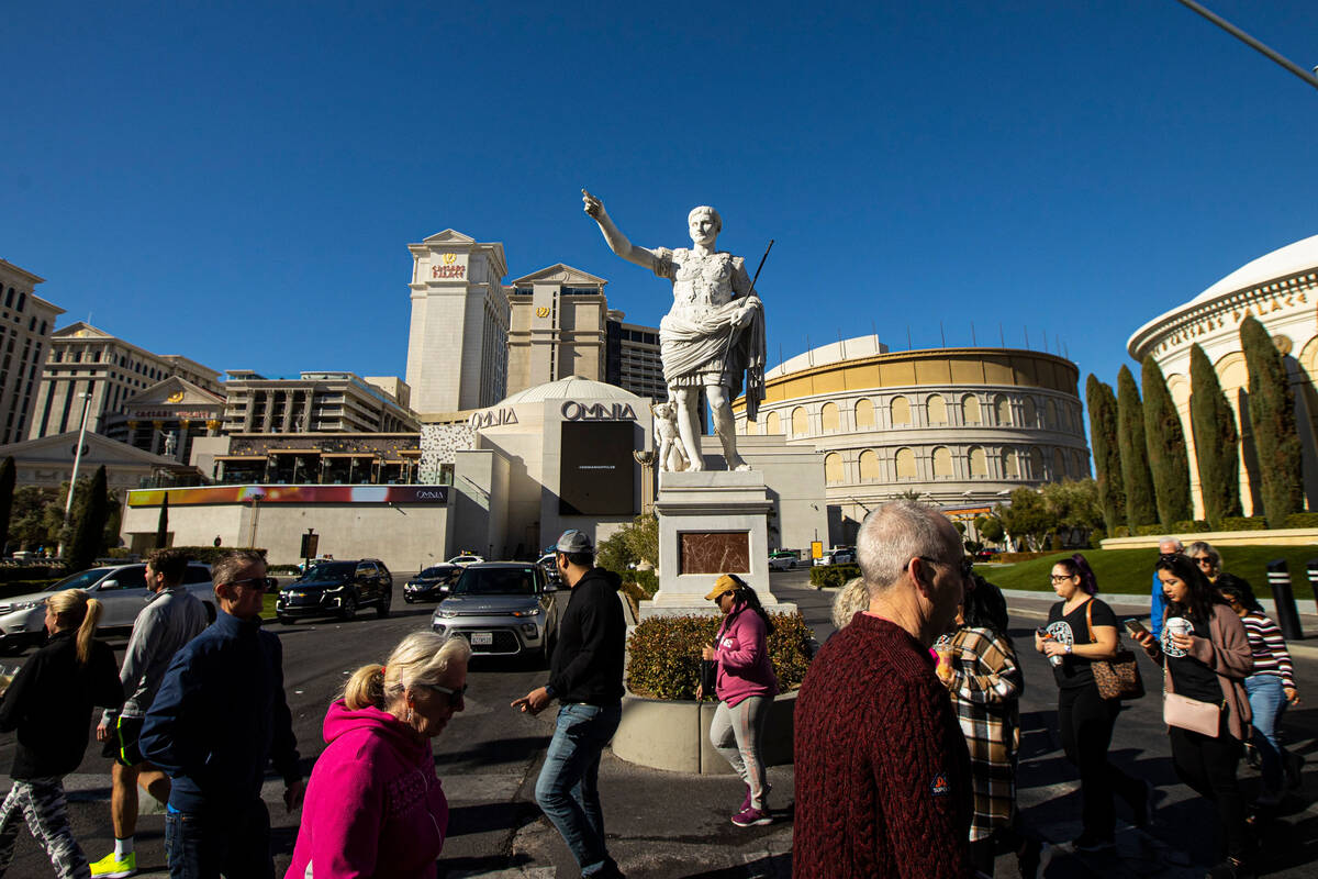 Pedestrians walk along the Las Vegas Strip outside of Caesars Palace on Thursday, Jan. 26, 2023 ...
