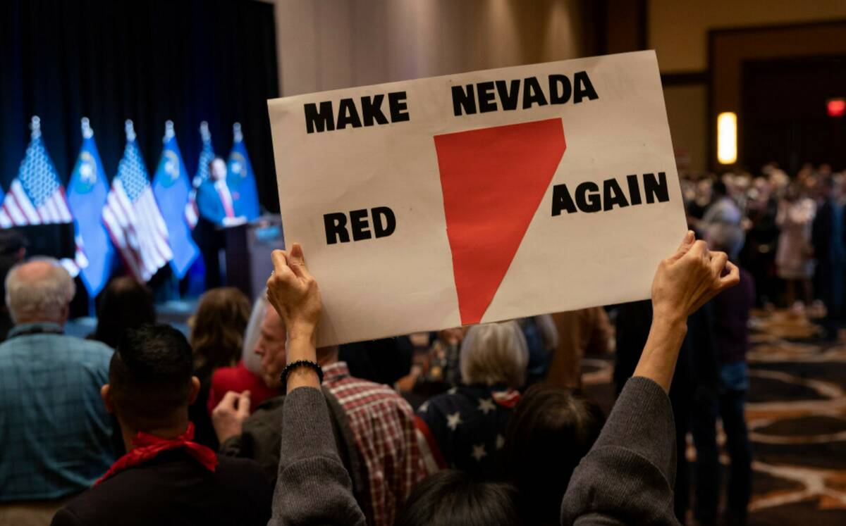 An attendee holds up a sign during a GOP midterm election watch party at Red Rock Casino on Tue ...