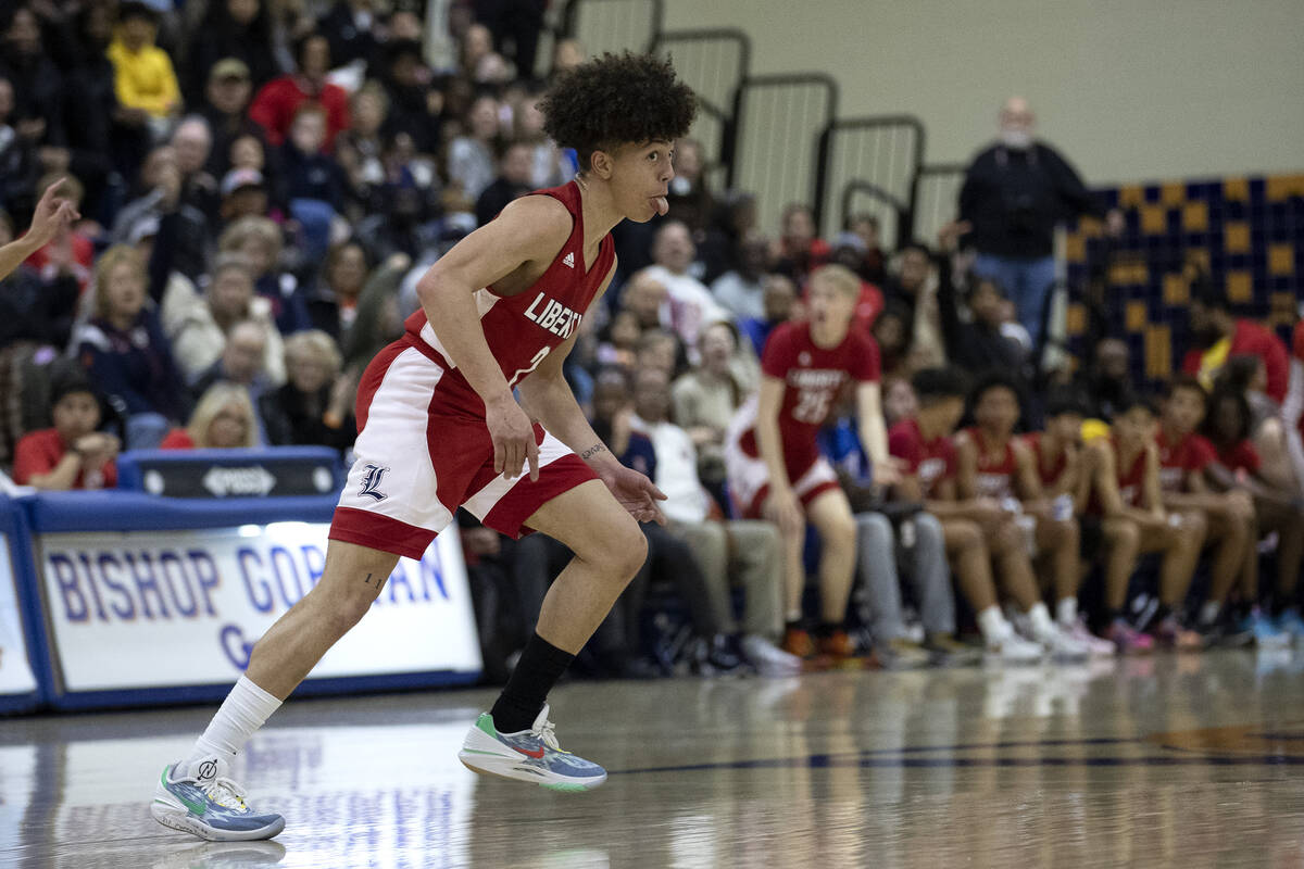 Liberty’s Angelo Kamala (2) sticks his tongue out toward the Bishop Gorman student secti ...