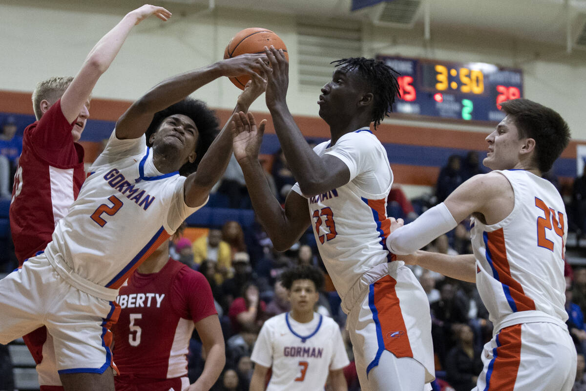 Bishop Gorman’s Keenan Bey (2) and Chris Nwuli (23) go for a rebound after Liberty&#x201 ...
