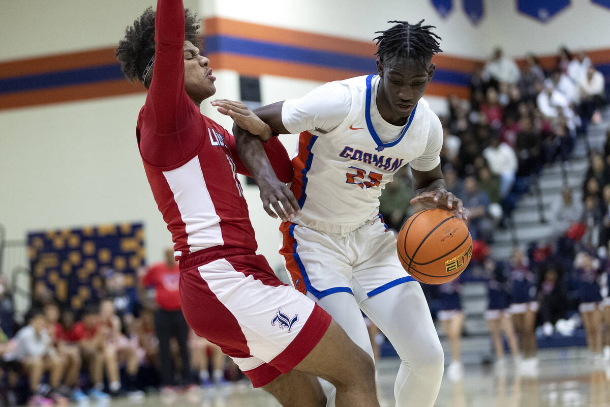 Bishop Gorman’s Chris Nwuli (23) attempts to dribble around Liberty’s Carlos Brad ...