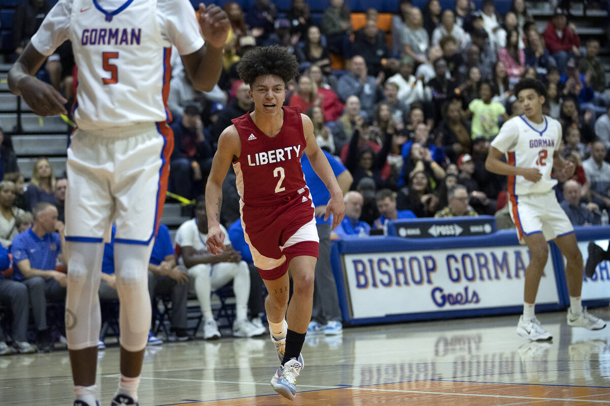 Liberty’s Angelo Kambala celebrates after scoring during a Class 5A boys high school bas ...