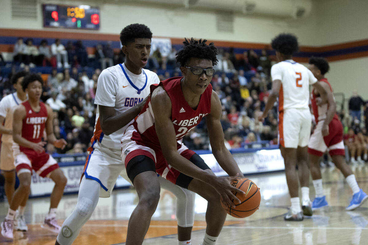Liberty’s Javares Reid (22) maneuvers around Bishop Gorman’s Jaxon Richardson, ce ...