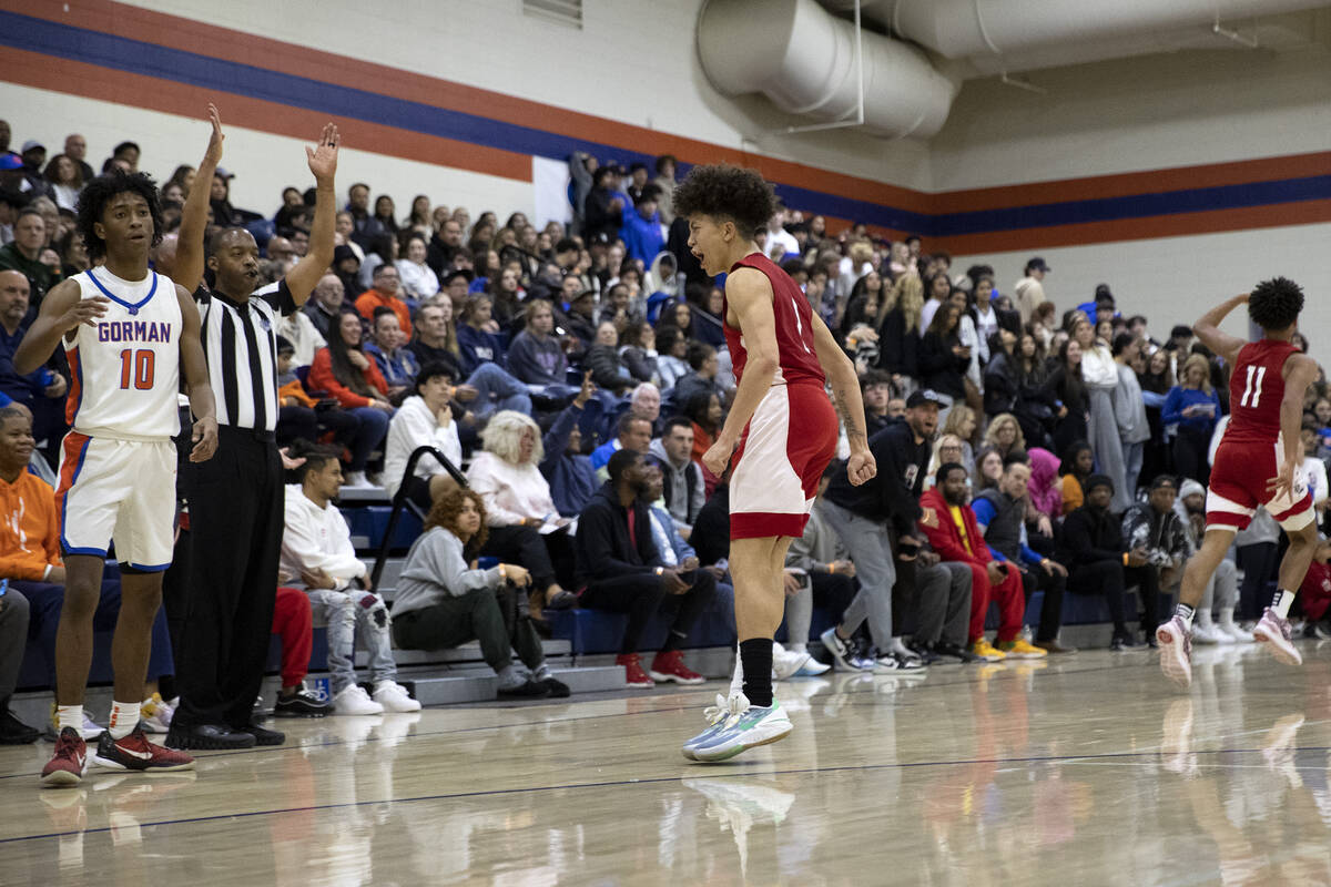 Liberty’s Angelo Kambala (2) celebrates after shooting a three-pointer while Bishop Gorm ...