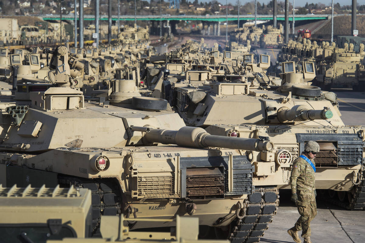 FILE - A soldier walks past a line of M1 Abrams tanks, Nov. 29, 2016, at Fort Carson in Colorad ...