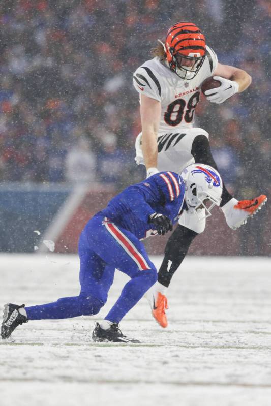 Cincinnati Bengals tight end Hayden Hurst (88) leaps over Buffalo Bills safety Jaquan Johnson ( ...