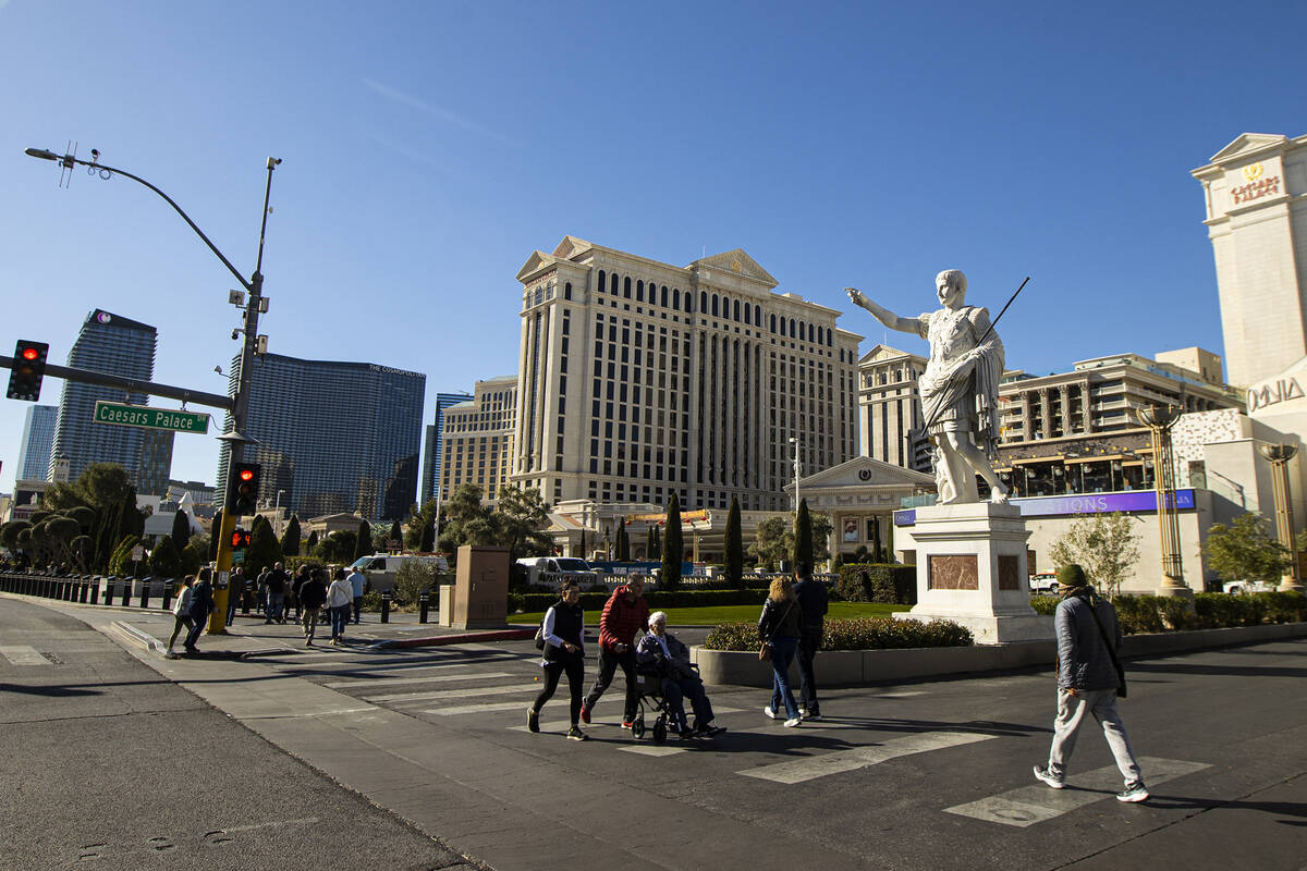 Pedestrians walk along the Las Vegas Strip outside of Caesars Palace on Thursday, Jan. 26, 2023 ...