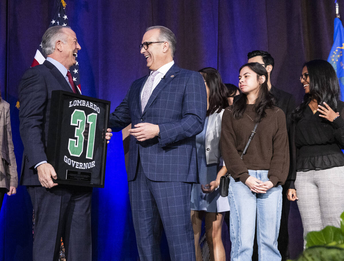 Gov. Joe Lombardo, left, shares a laugh with CCSD Superintendent Dr. Jesus F. Jara after receiv ...