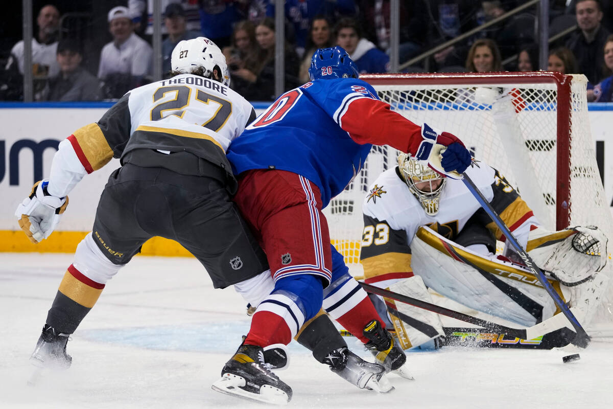 Vegas Golden Knights goaltender Adin Hill (33) and defenseman Shea Theodore (27) defend against ...