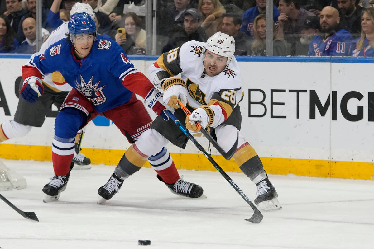 New York Rangers defenseman Braden Schneider (4) defends against Vegas Golden Knights left wing ...