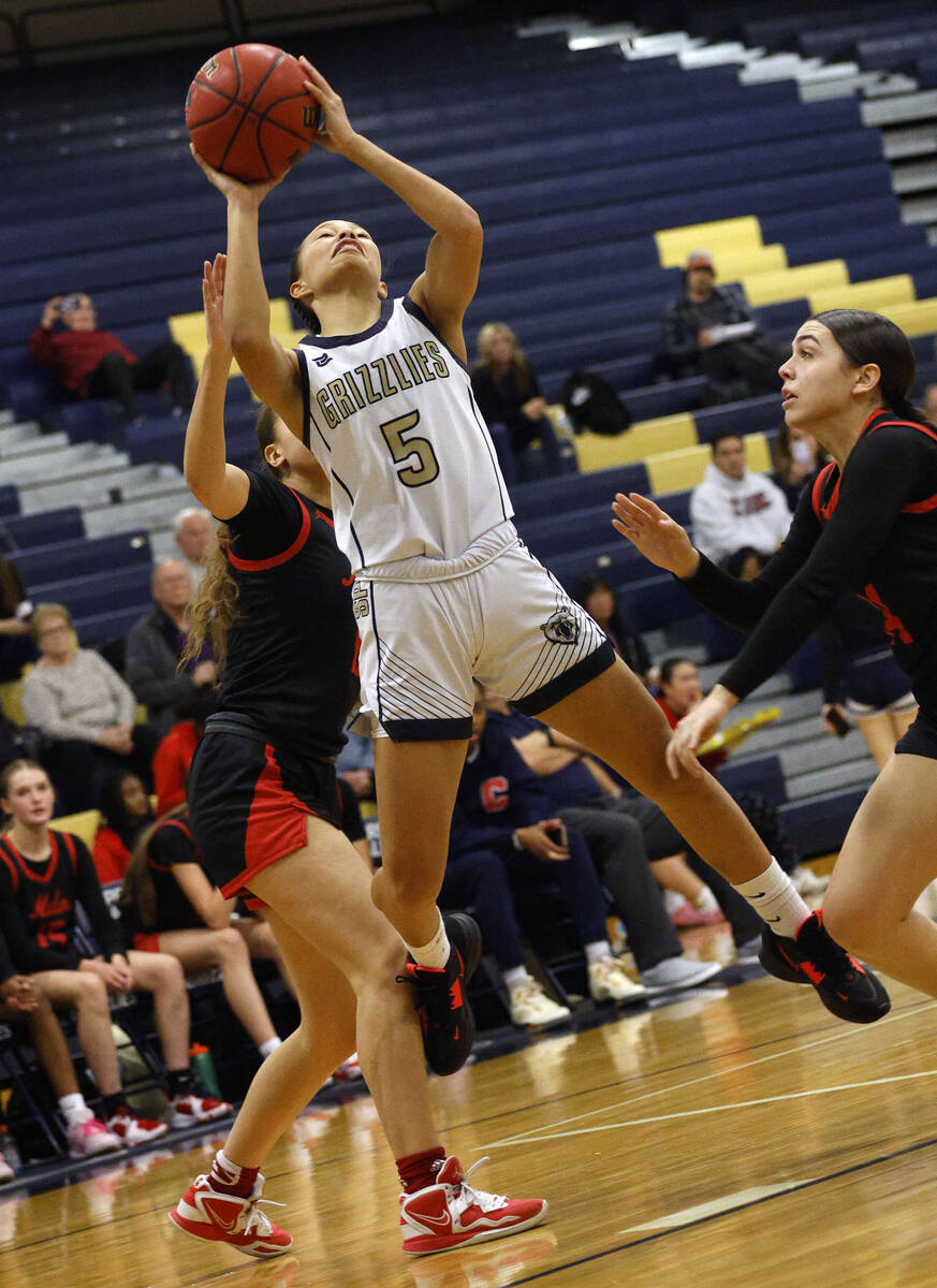 Spring Valley's Gia McFadden (5) shoots the ball as Coronado's Kaylee Walters (14), right, look ...