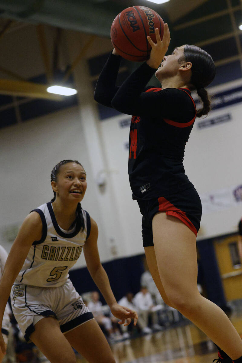 Coronado's Kaylee Walters (14), right, goes to the basket as Spring Valley's Gia McFadden (5) l ...
