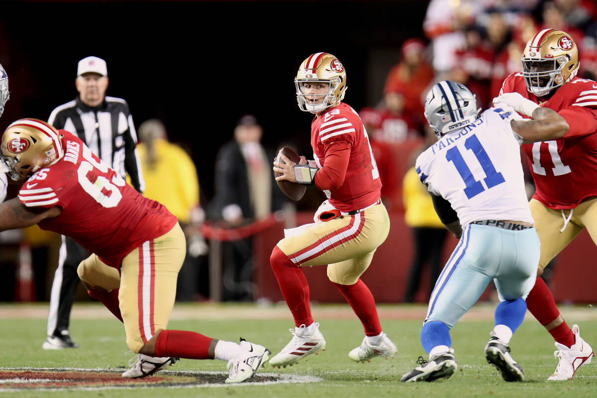 San Francisco 49ers quarterback Brock Purdy (13) looks to pass during an NFL divisional round p ...