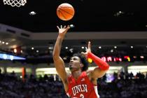 UNLV guard Shane Nowell tries to score over New Mexico's Morris Udeze in the first half of an N ...