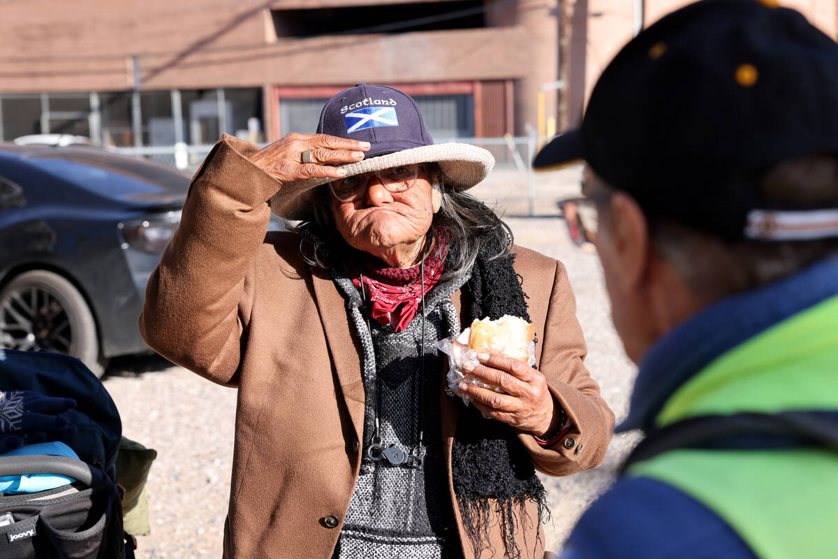 Richard Birmingham, right, offers food and resource information to Edna De La Fuente during his ...