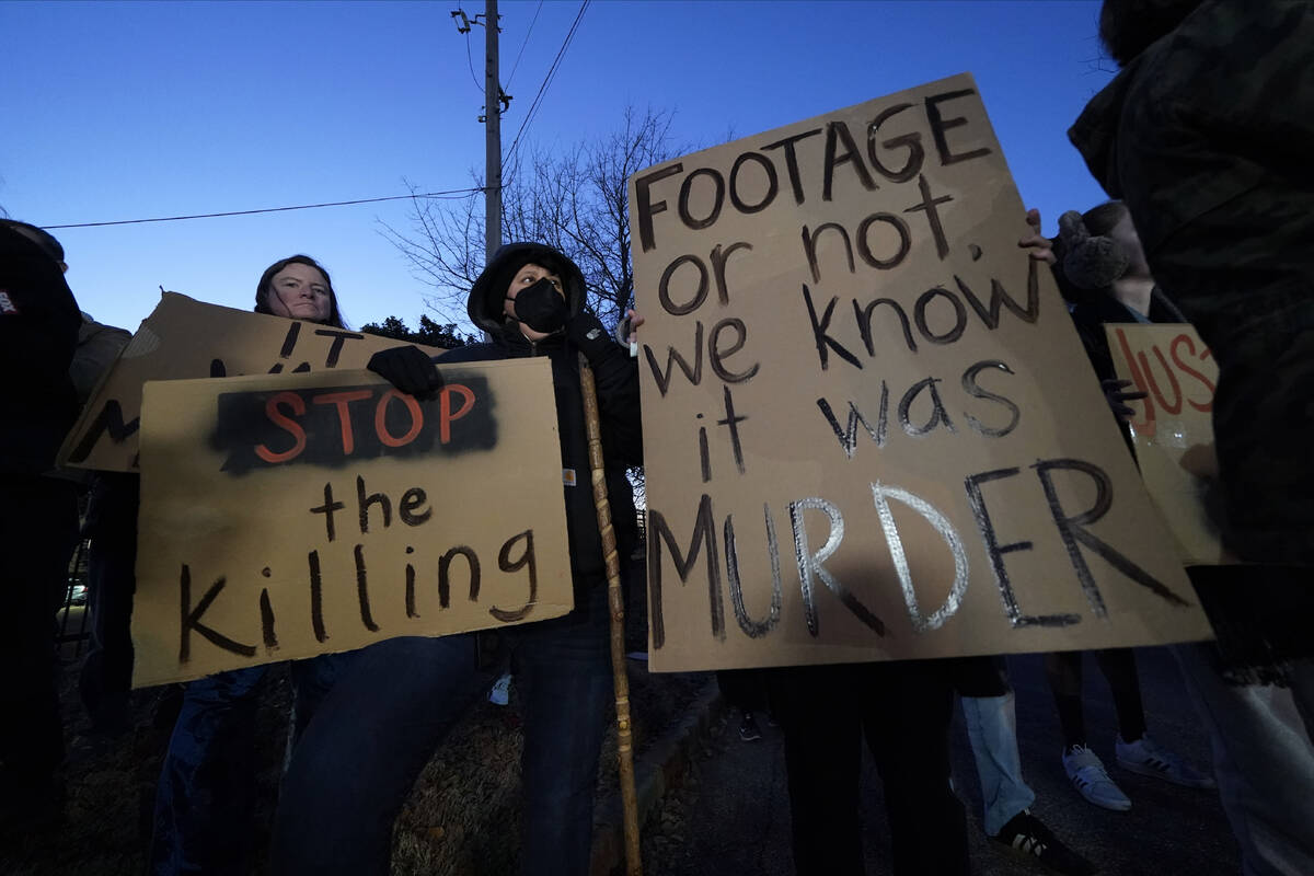 Protesters hold signs Friday, Jan. 27, 2023, in Memphis, Tenn., as authorities are set to relea ...