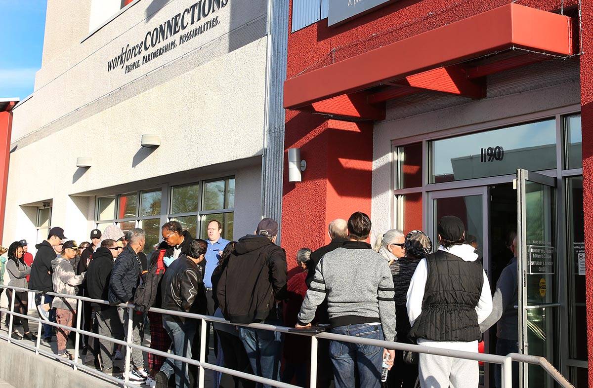 People wait in line at One-Stop Career Center on Monday, March 16, 2020, in Las Vegas. (Bizuaye ...