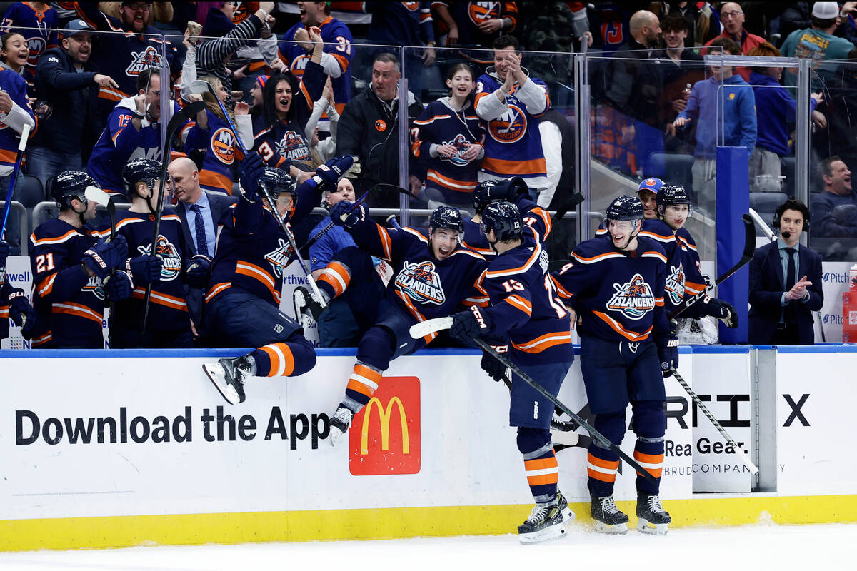 New York Islanders center Mathew Barzal (13) is congratulated by teammates after scoring the ga ...
