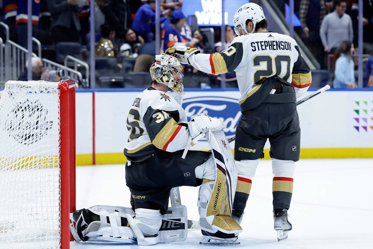 Vegas Golden Knights goaltender Logan Thompson and Chandler Stephenson (20) react after giving ...