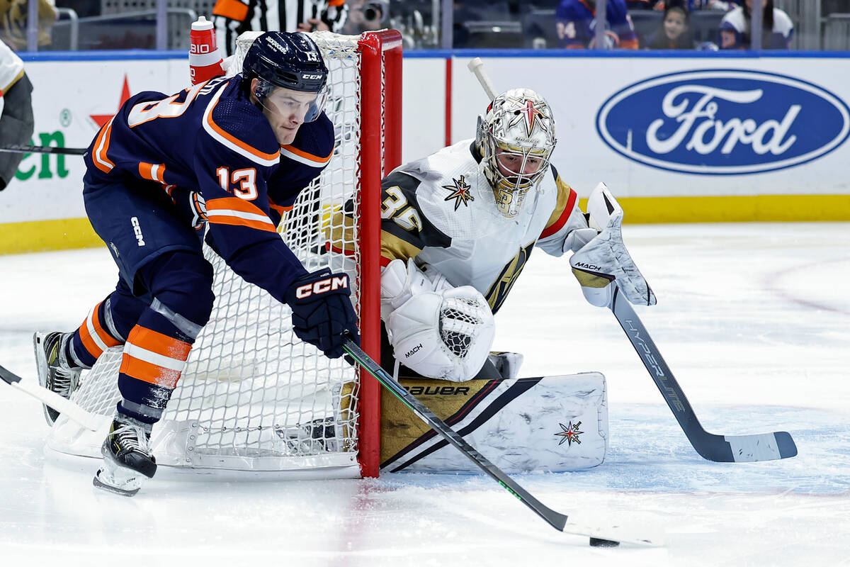 Vegas Golden Knights goaltender Logan Thompson defends against New York Islanders center Mathew ...