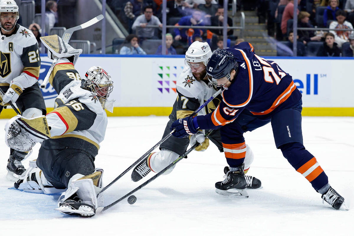 Vegas Golden Knights goaltender Logan Thompson stops a shot by New York Islanders left wing And ...