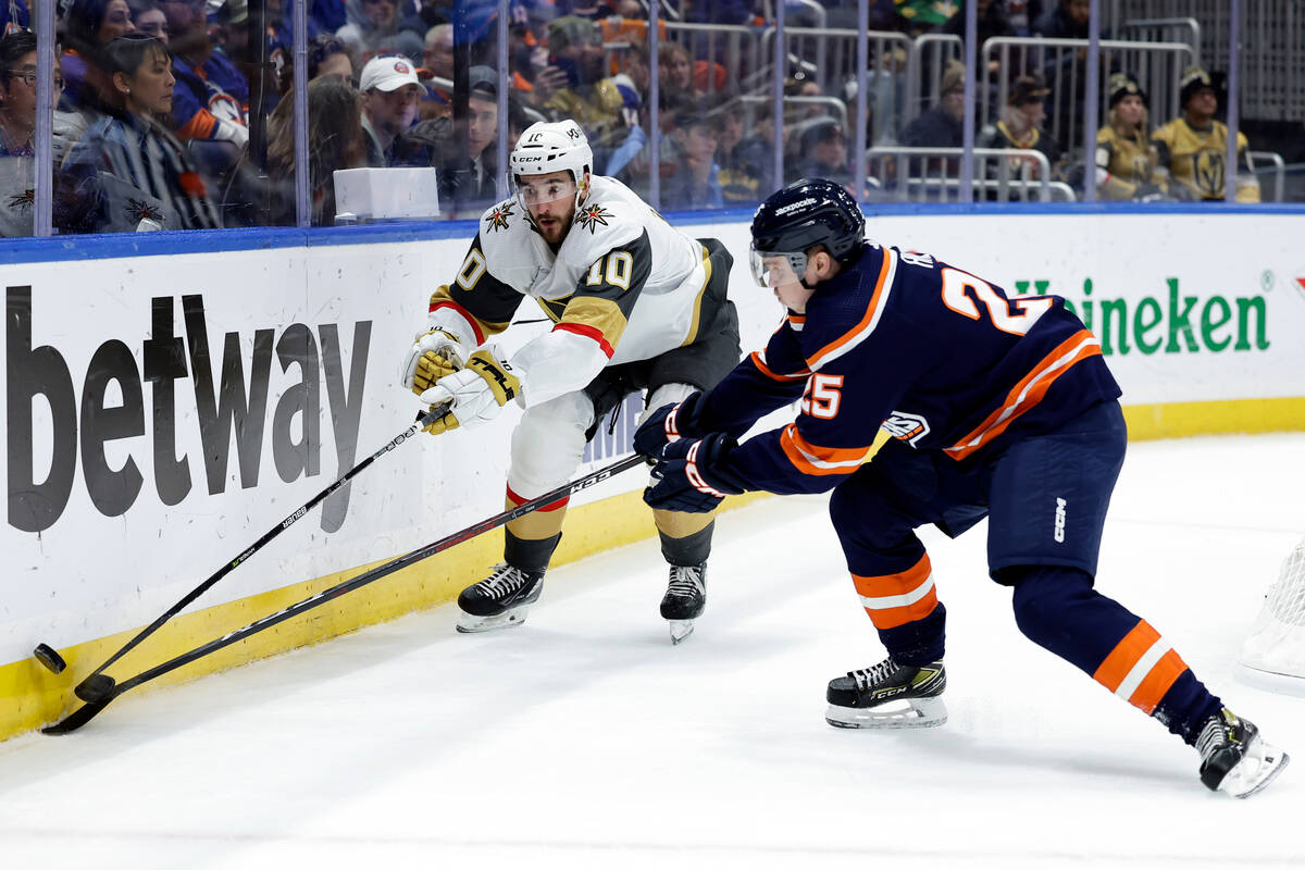 Vegas Golden Knights center Nicolas Roy (10) and New York Islanders defenseman Sebastian Aho re ...