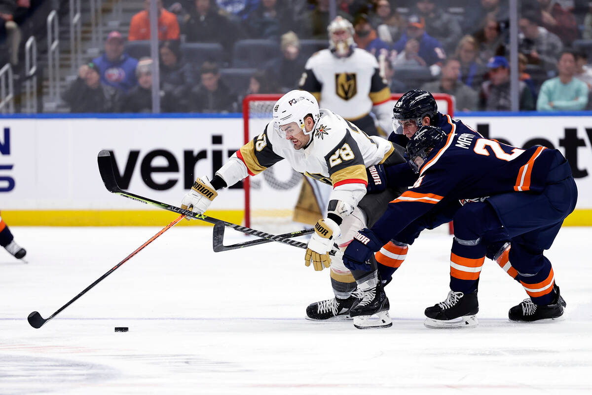 Vegas Golden Knights left wing William Carrier (28) controls the puck past New York Islanders d ...