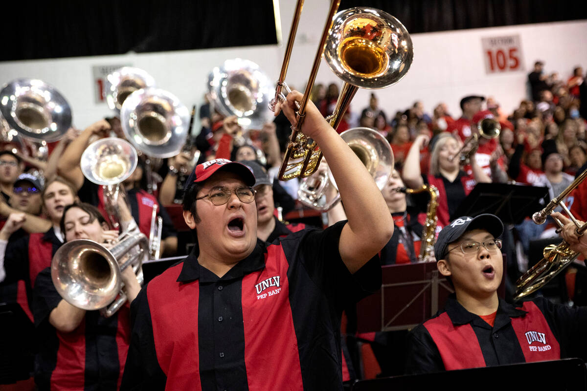 The UNLV pep band shouts for their team during the first half of an NCAA college basketball gam ...