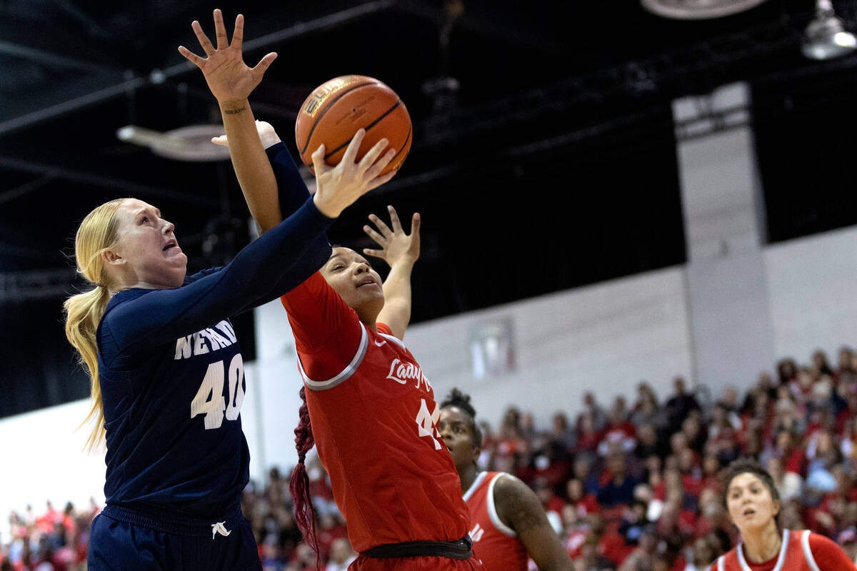 Nevada Wolf Pack forward Megan Ormiston (40) attempts to shoot while UNLV Lady Rebels forward A ...