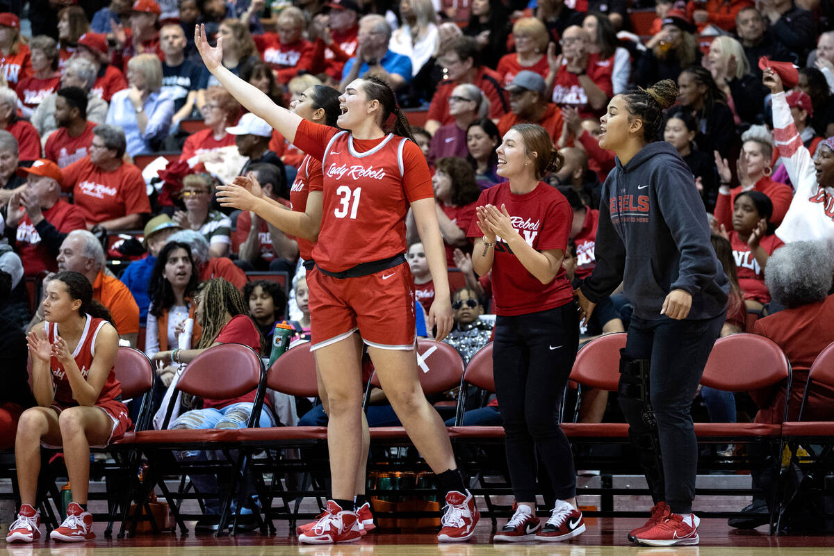 The UNLV Lady Rebels bench cheers for their team after they scored during the first half of an ...