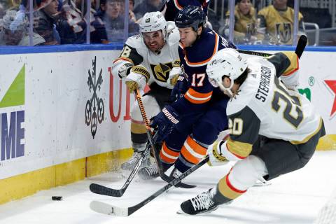 New York Islanders left wing Matt Martin (17) battles for the puck with Vegas Golden Knights le ...