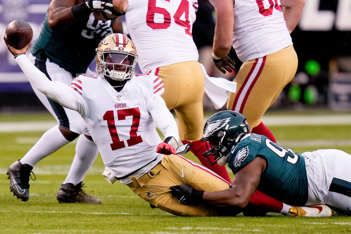 San Francisco 49ers quarterback Josh Johnson (17) passes while being tackled by Philadelphia Ea ...