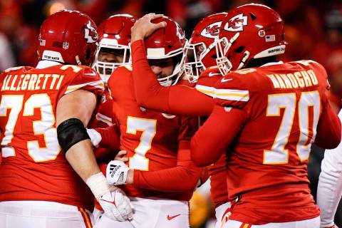 Kansas City Chiefs place kicker Harrison Butker (7) celebrates with teammates after his game wi ...
