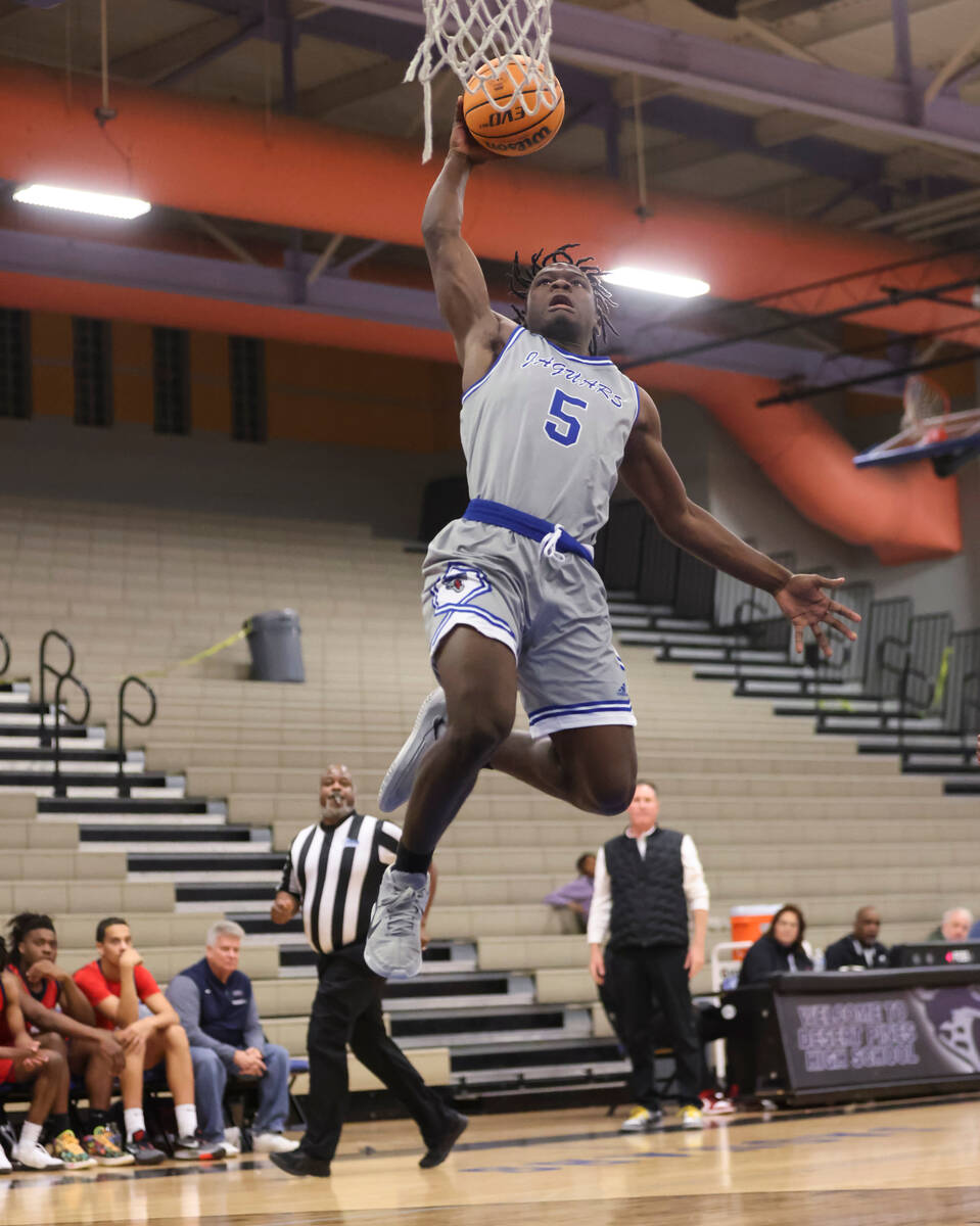 Desert Pines' Greg Burrell (5) lays up the ball against Coronado during the first half of a bas ...