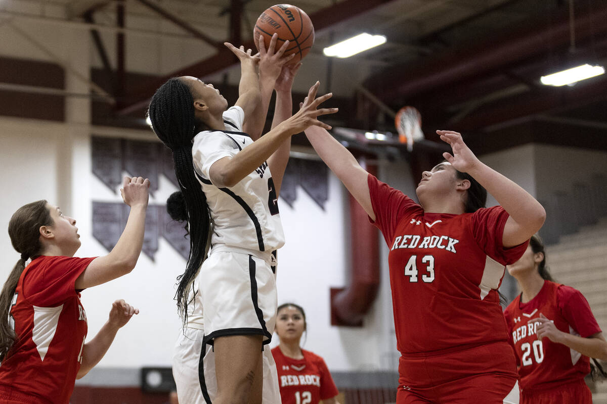Cimarron-Memorial’s Amaya Payne, center left, and Doral’s Amanda Orasi (43) jumps for a reb ...